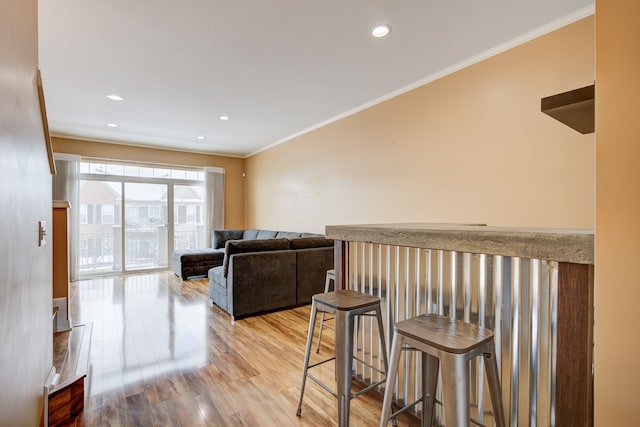 living room with hardwood / wood-style flooring and crown molding