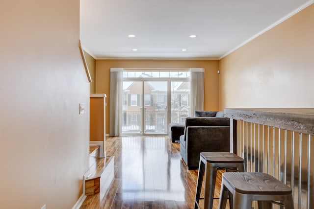 living room featuring hardwood / wood-style floors and crown molding