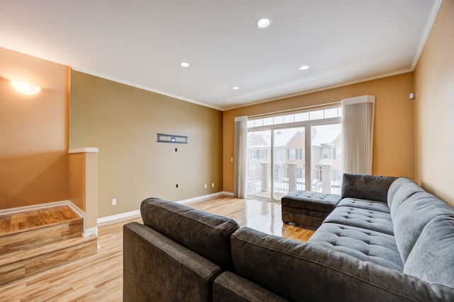 living room featuring light wood-type flooring and ornamental molding