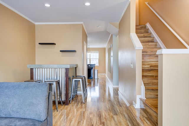 corridor featuring light hardwood / wood-style floors and crown molding