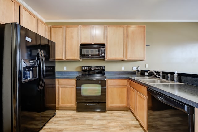 kitchen with crown molding, sink, black appliances, and light wood-type flooring