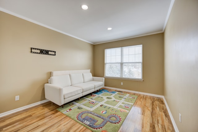 living room with hardwood / wood-style floors and ornamental molding