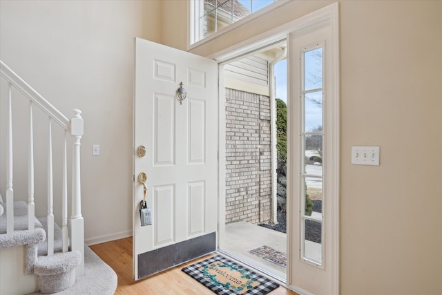 foyer entrance featuring hardwood / wood-style floors and a healthy amount of sunlight