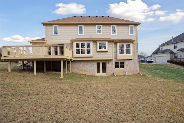 rear view of house featuring a deck and a yard