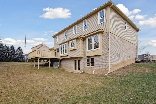 back of house with a lawn and a wooden deck