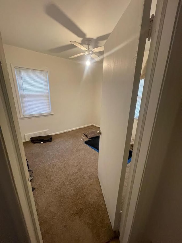 spare room with carpet and ceiling fan