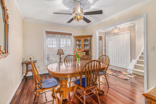 dining room featuring hardwood / wood-style floors, ceiling fan with notable chandelier, and ornamental molding