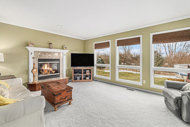 living room featuring crown molding, a wealth of natural light, and carpet