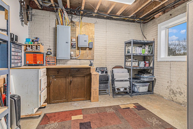 basement with brick wall and electric panel