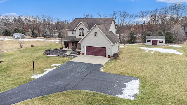 view of front facade featuring a storage shed, a garage, and a front lawn