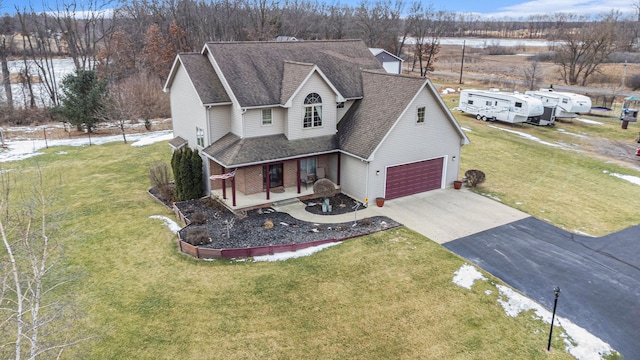 view of front of house featuring covered porch and a front lawn