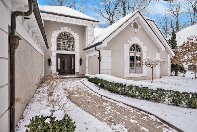 view of snow covered property entrance