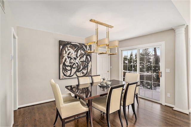 dining room featuring dark hardwood / wood-style flooring and decorative columns