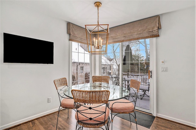 dining area featuring hardwood / wood-style flooring and a notable chandelier