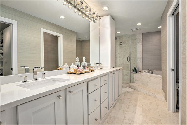 bathroom featuring vanity, tile patterned flooring, and shower with separate bathtub