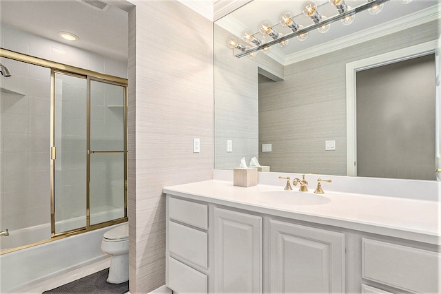 full bathroom with toilet, tile walls, ornamental molding, vanity, and shower / bath combination with glass door