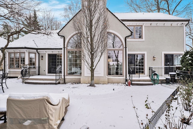 view of snow covered rear of property