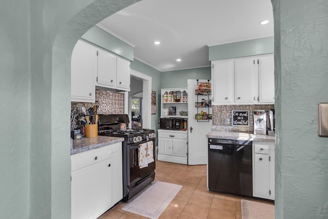 kitchen with white cabinets, light tile patterned floors, decorative backsplash, and black appliances