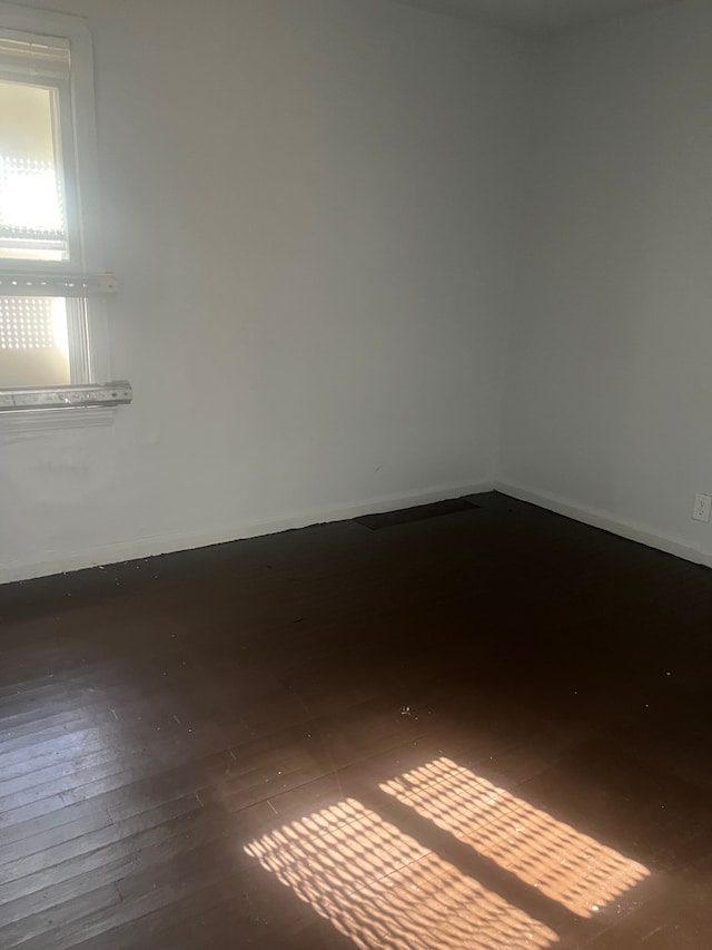 empty room with hardwood / wood-style flooring