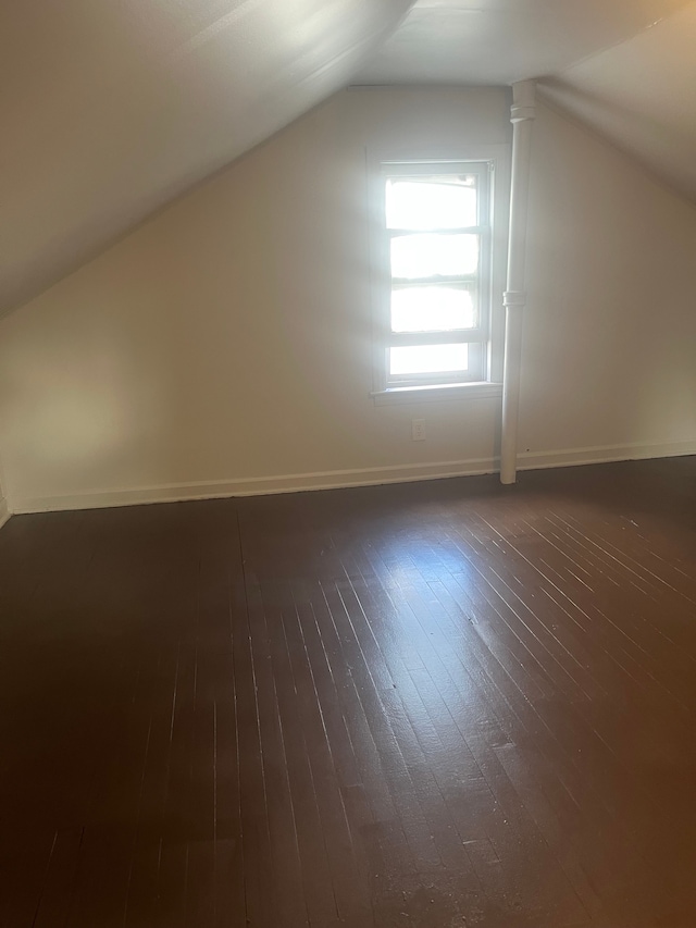 bonus room with dark hardwood / wood-style floors and lofted ceiling