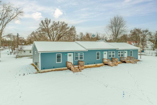 view of snow covered rear of property