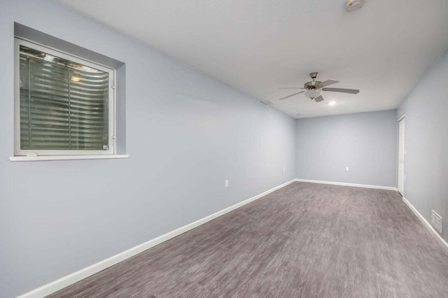 empty room with hardwood / wood-style floors and ceiling fan