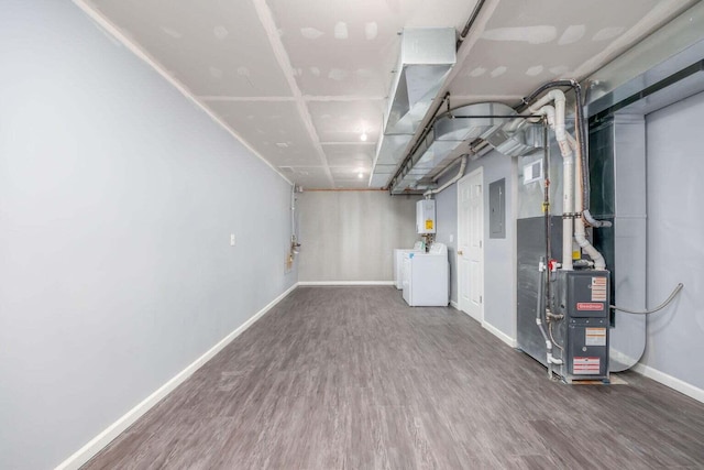 basement with independent washer and dryer, electric panel, and hardwood / wood-style flooring