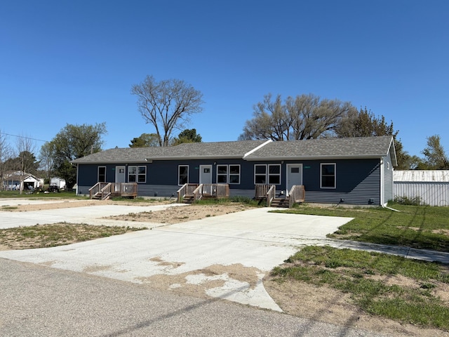 216 W 1st St, Evart, MI 49631 - ranch-style home featuring driveway and fence
