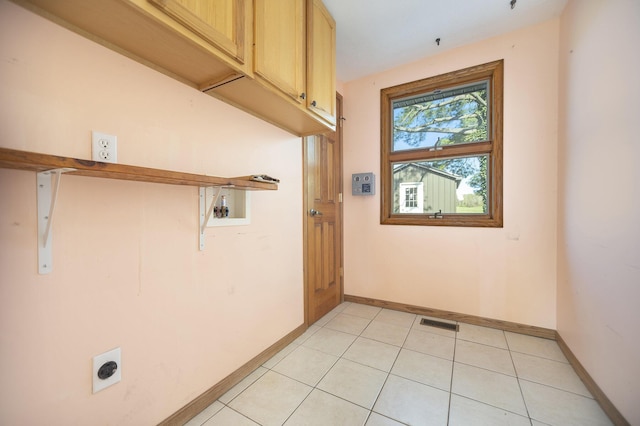 laundry room with electric dryer hookup, cabinets, and hookup for a washing machine