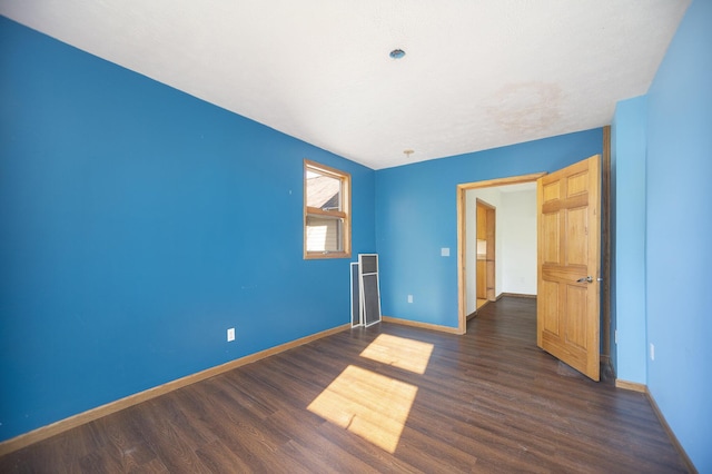 unfurnished room with dark hardwood / wood-style floors