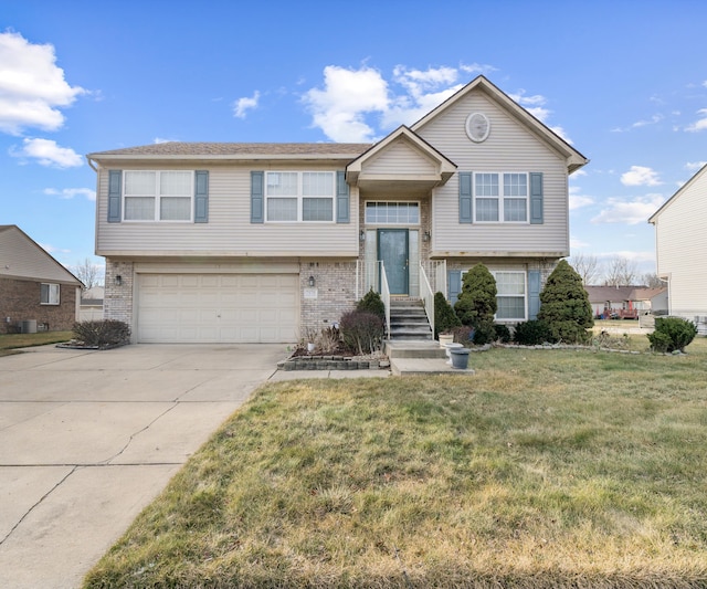 split foyer home with a front yard and a garage