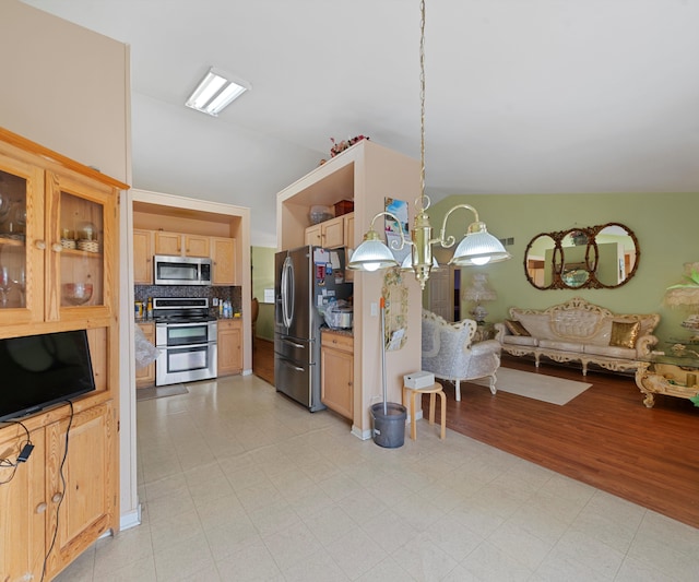 kitchen with hanging light fixtures, a chandelier, decorative backsplash, light brown cabinetry, and appliances with stainless steel finishes