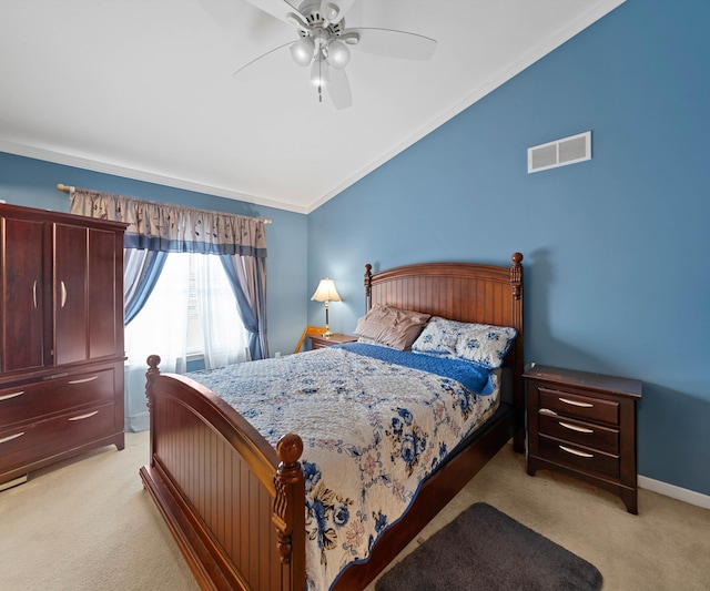 carpeted bedroom with ceiling fan, crown molding, and vaulted ceiling