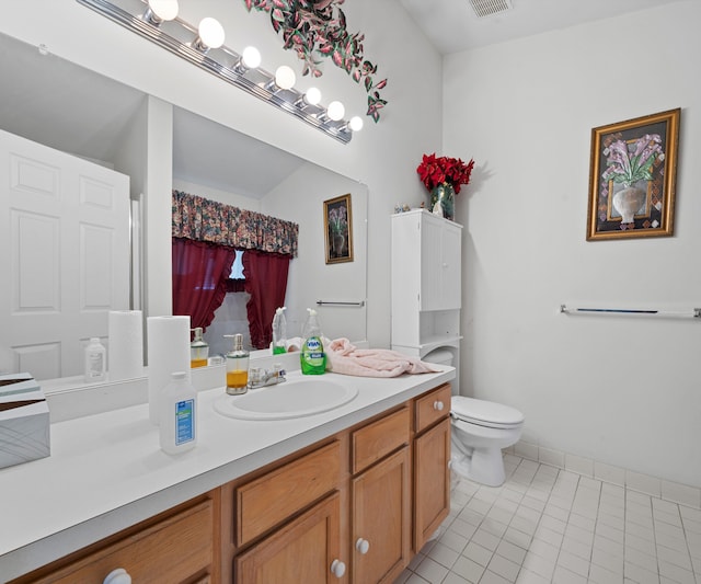 bathroom featuring tile patterned floors, walk in shower, vanity, and toilet