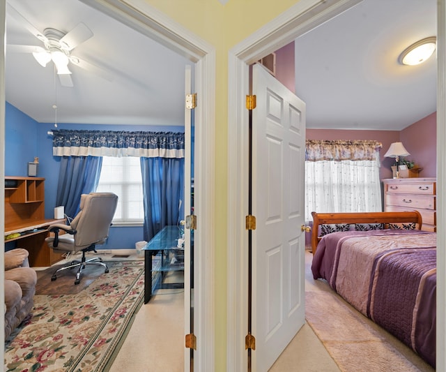 bedroom with ceiling fan and light carpet