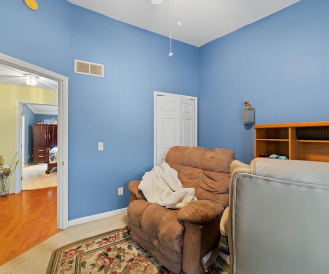 sitting room featuring ceiling fan and wood-type flooring