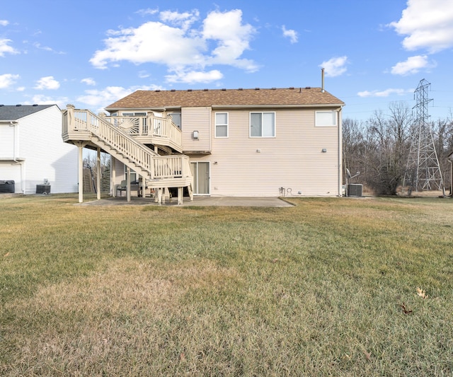 rear view of property with a lawn, a patio area, a deck, and central air condition unit