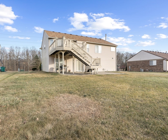 back of house featuring a lawn, a patio area, and a deck