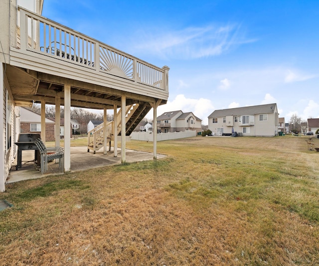 view of yard with a wooden deck and a patio