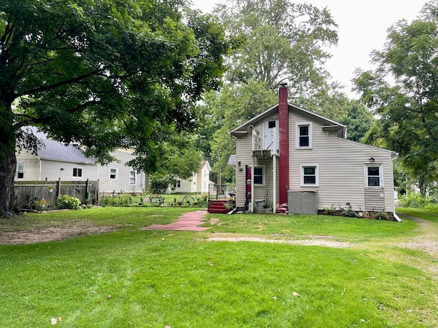 rear view of house featuring a lawn