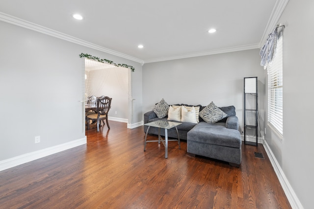 living room with dark hardwood / wood-style floors and ornamental molding