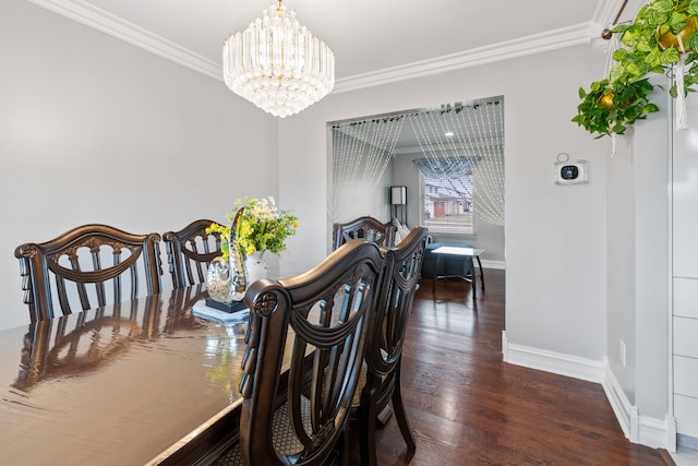 dining room with dark hardwood / wood-style flooring, an inviting chandelier, and crown molding