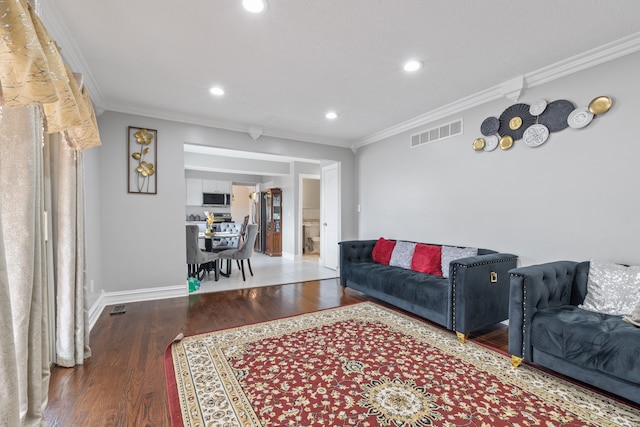 living room featuring wood-type flooring and ornamental molding