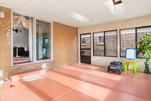 unfurnished sunroom with a skylight