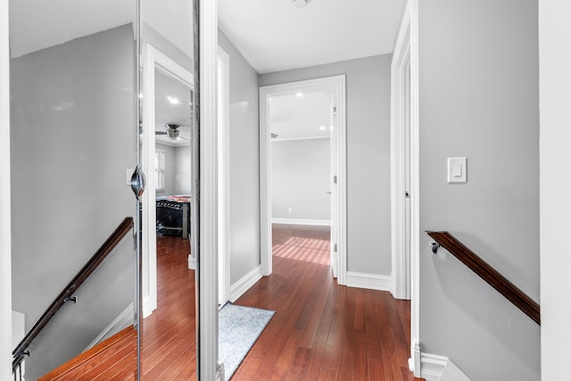 corridor with dark hardwood / wood-style flooring