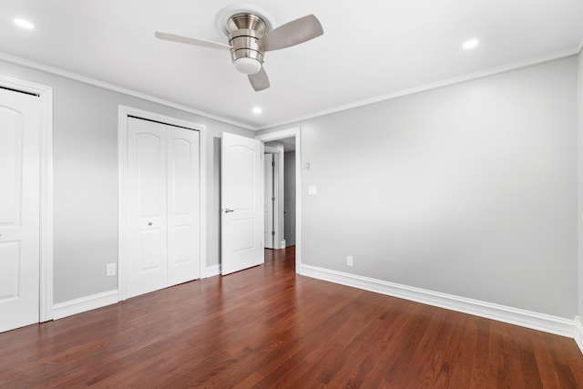 unfurnished bedroom with ceiling fan, dark hardwood / wood-style floors, and ornamental molding