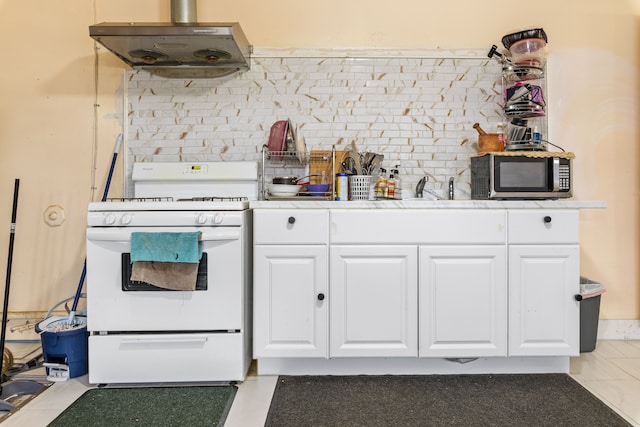 kitchen featuring white cabinets, backsplash, white stove, and range hood