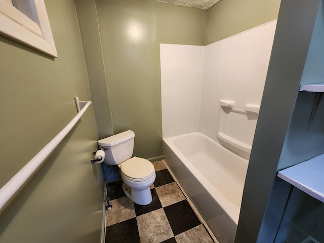 bathroom featuring shower / bathing tub combination and toilet