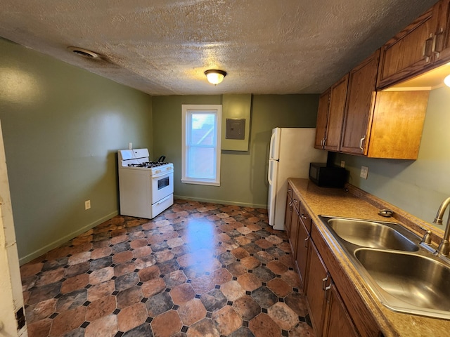 kitchen with a textured ceiling, electric panel, sink, and white appliances