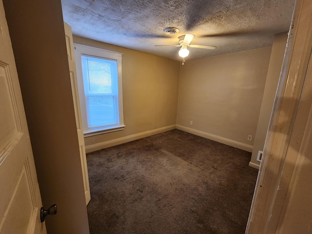 unfurnished room with dark colored carpet, a textured ceiling, and ceiling fan